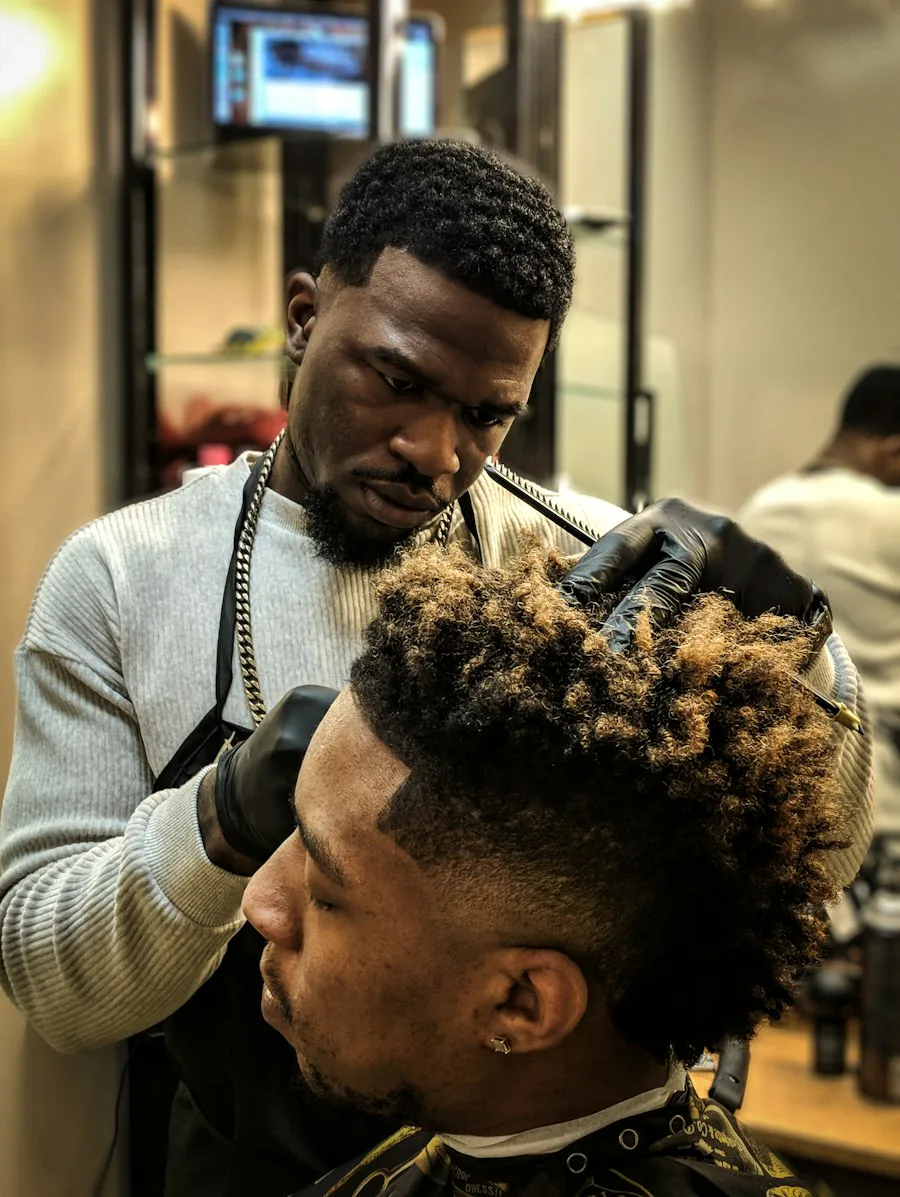 A barber concentrating on a fade at his own chair